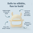 Baby teething ring with text highlighting its features on a light blue background. Lightweight and easy to hold. Textured surface massages sore gums. Freezer and dishwasher safe. Textured on both sides.