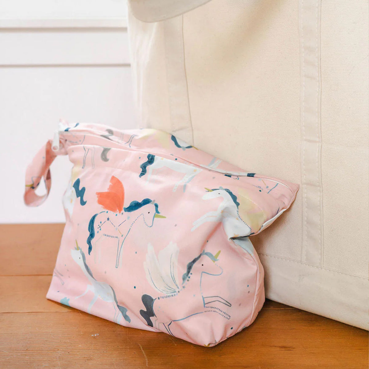 wet dry bag with unicorn pattern on a wooden floor.